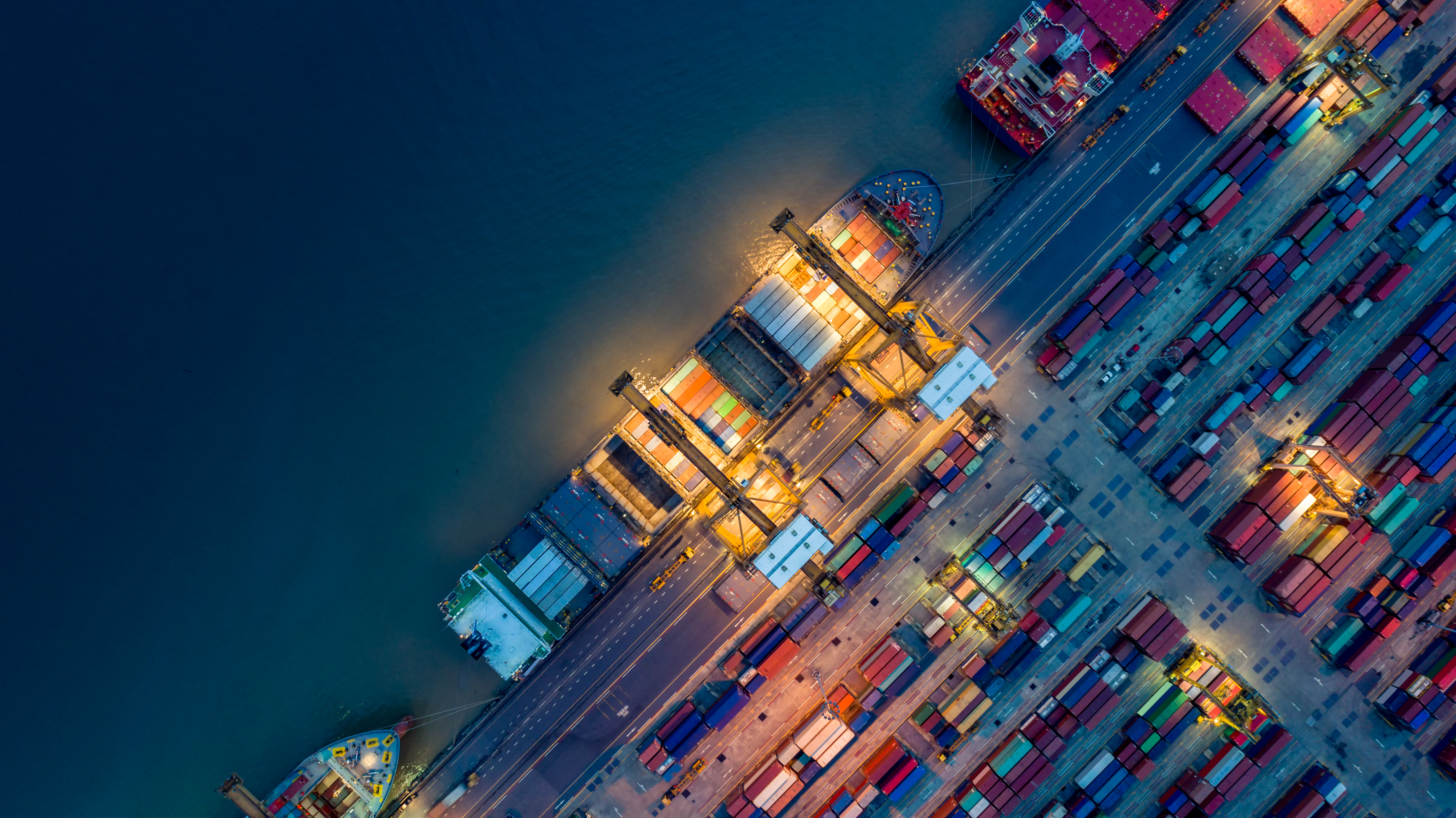 Logistics and transportation of Container Cargo ship and Cargo plane with working crane bridge in shipyard at sunrise, logistic import export and transport industry background